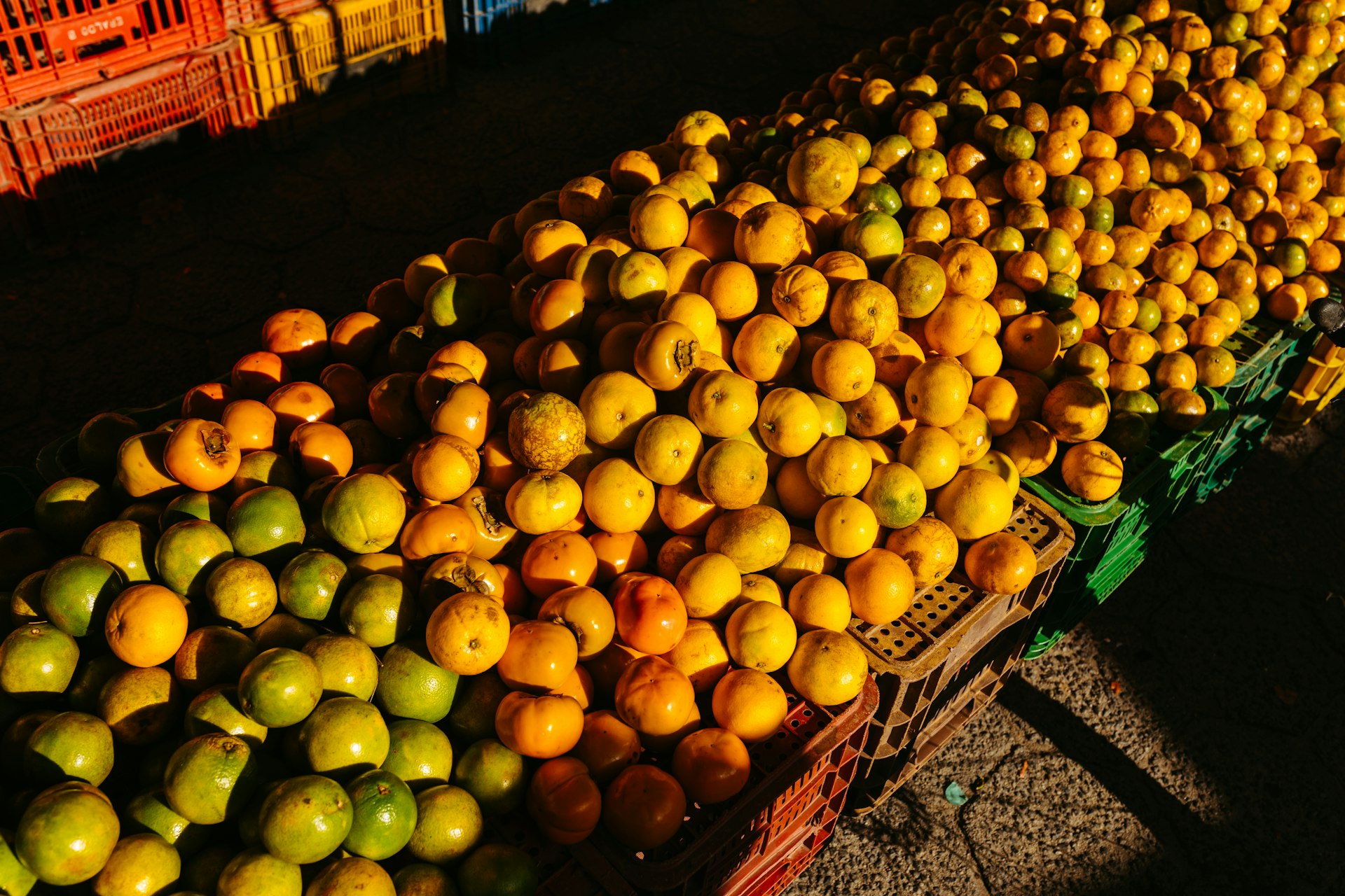 a pile of oranges and lemons sitting next to each other